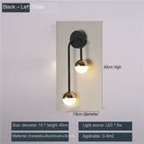 Ring and glass globe wall sconce on a white background