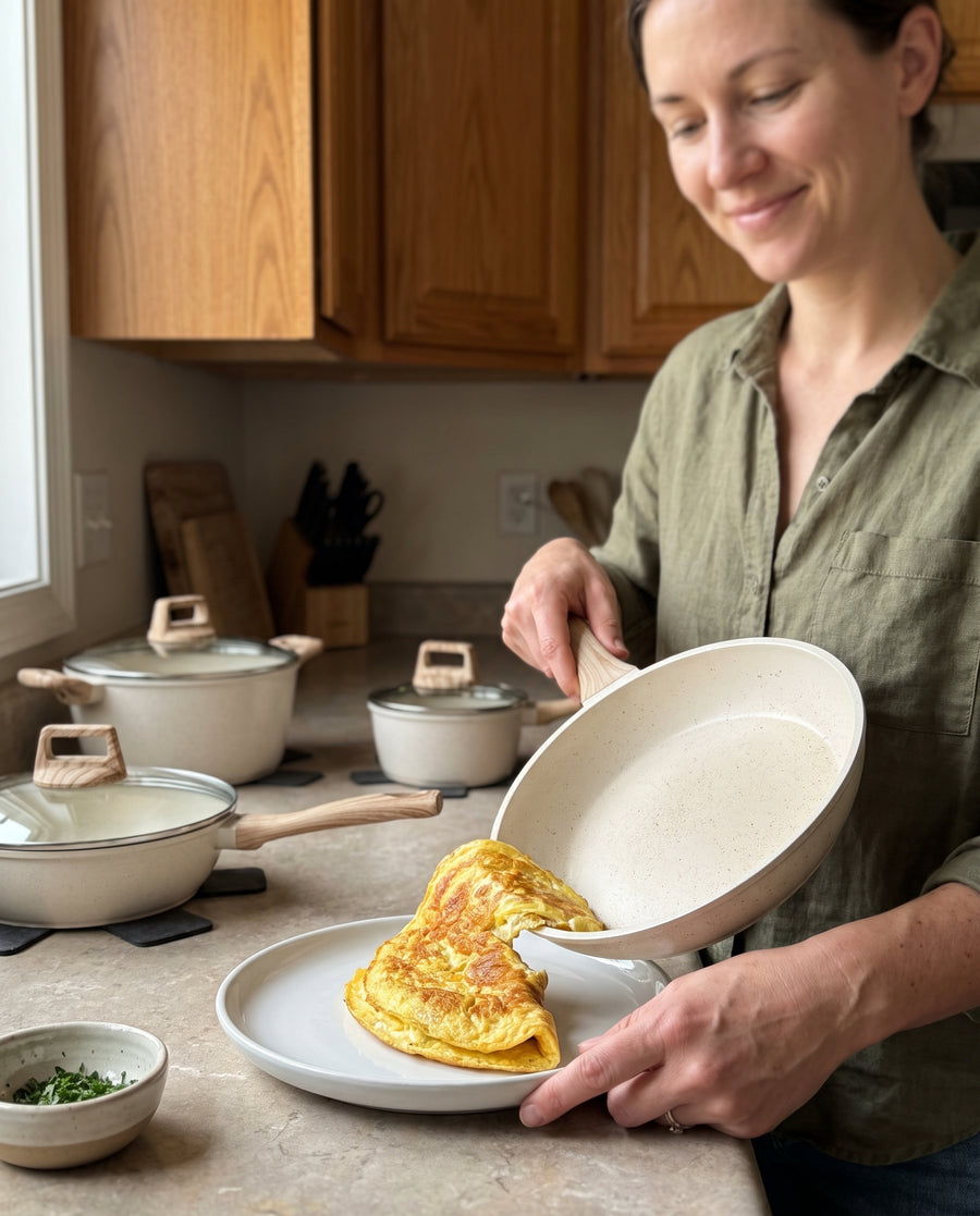 An omelette sliding cleanly out of the cream speckle frying pan