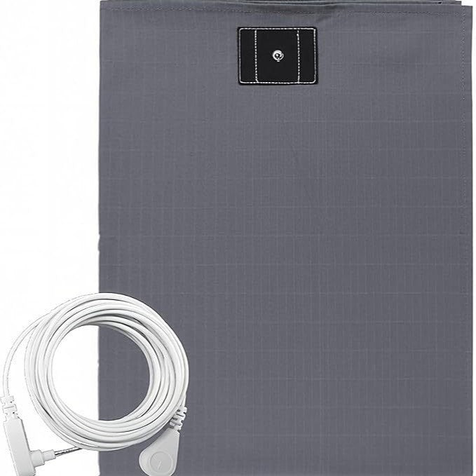 The cord plugs into the round ground port of a standard wall outlet