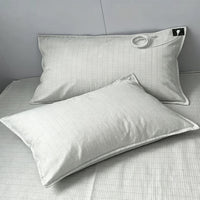 Two Grounding Pillowcases on a made bed