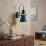 Horn shade sconce lit above a sideboard
