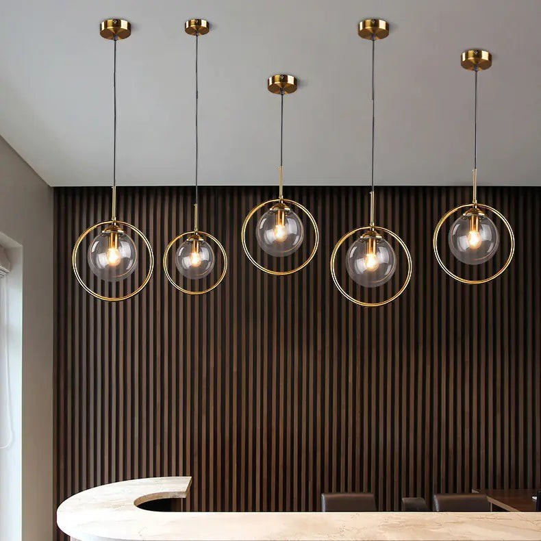 Row of glass globe pendants over a kitchen counter