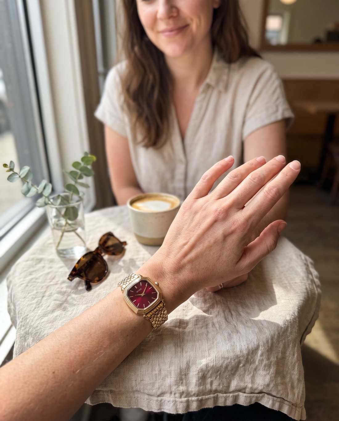 Wearing the MYAR watch at a café table