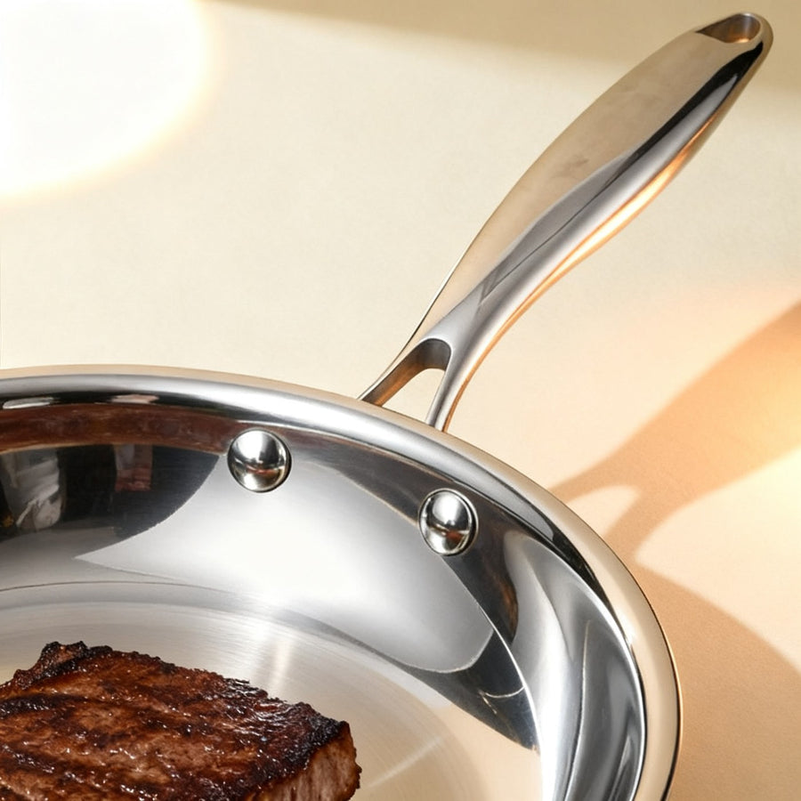 Close-up of the riveted stainless handle and mirror rim
